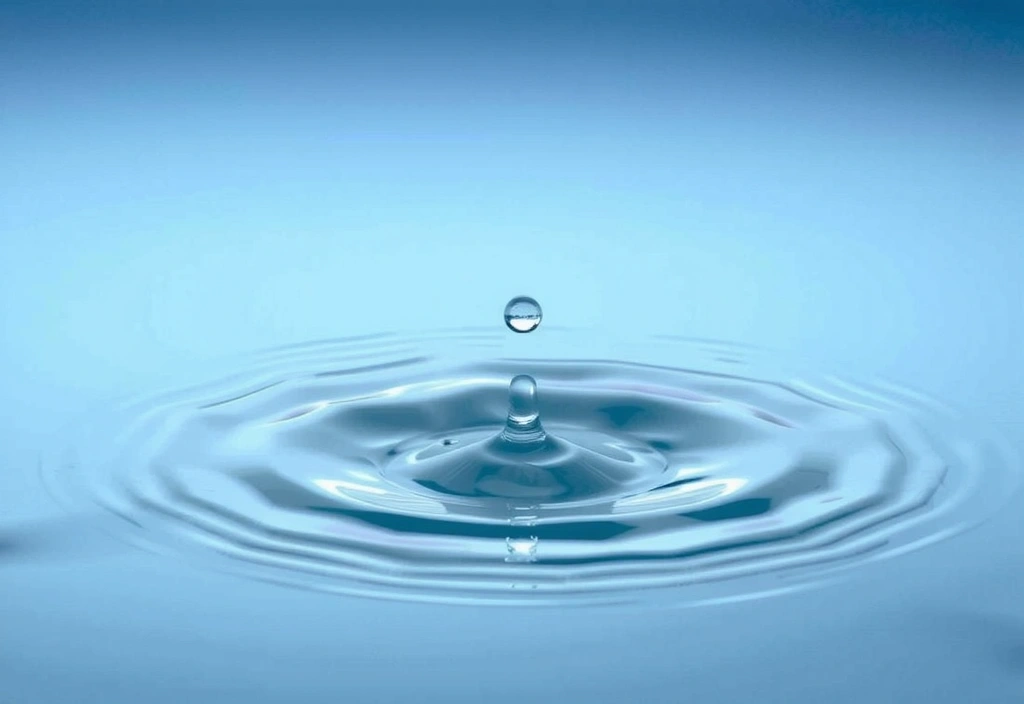 A pristine, clear droplet of water falling into a pool, creating perfect ripples, symbolizing purity.